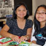 Art Advisory Student Jessica Reyes and her mom, Josie work together.